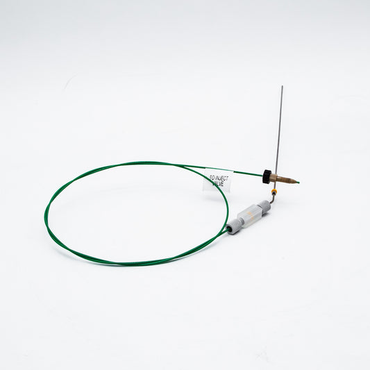 Device with green cable and needle on a white background