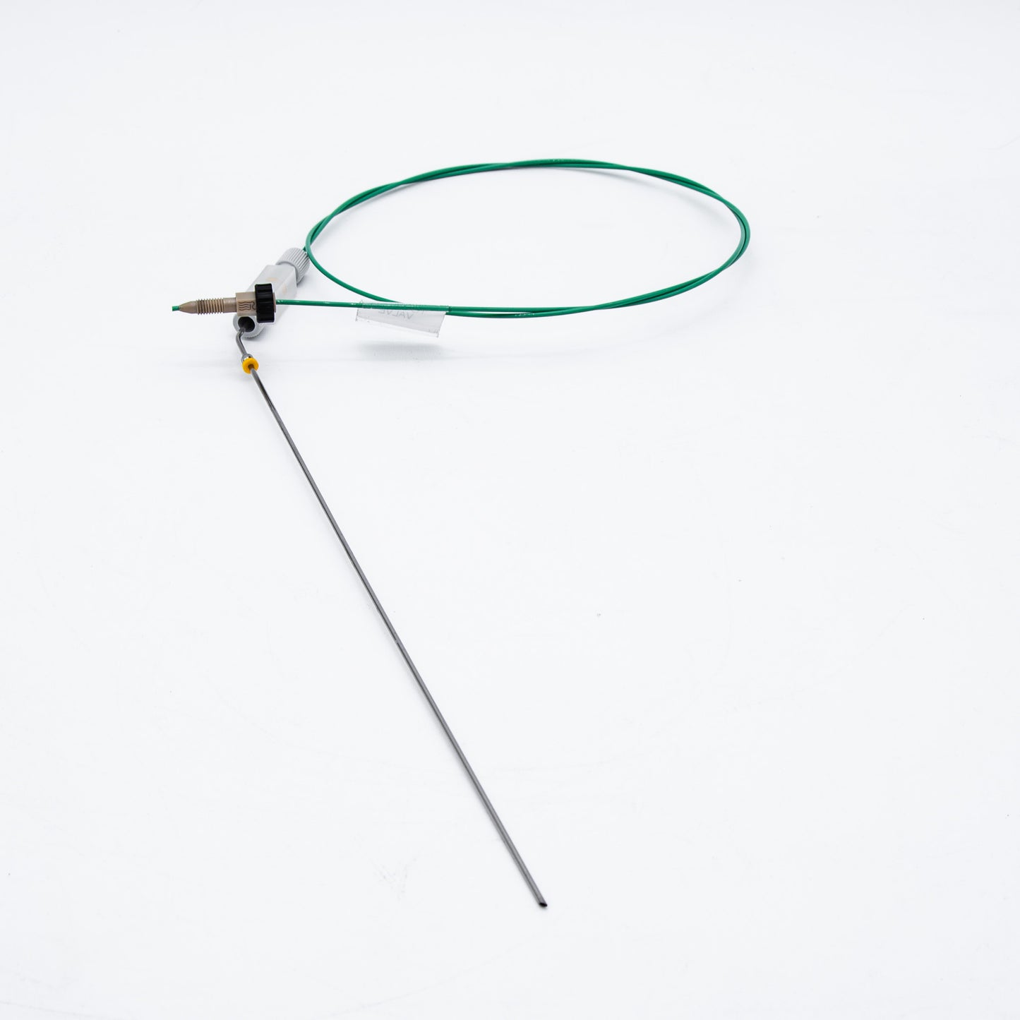 Device with green cable and needle on a white background