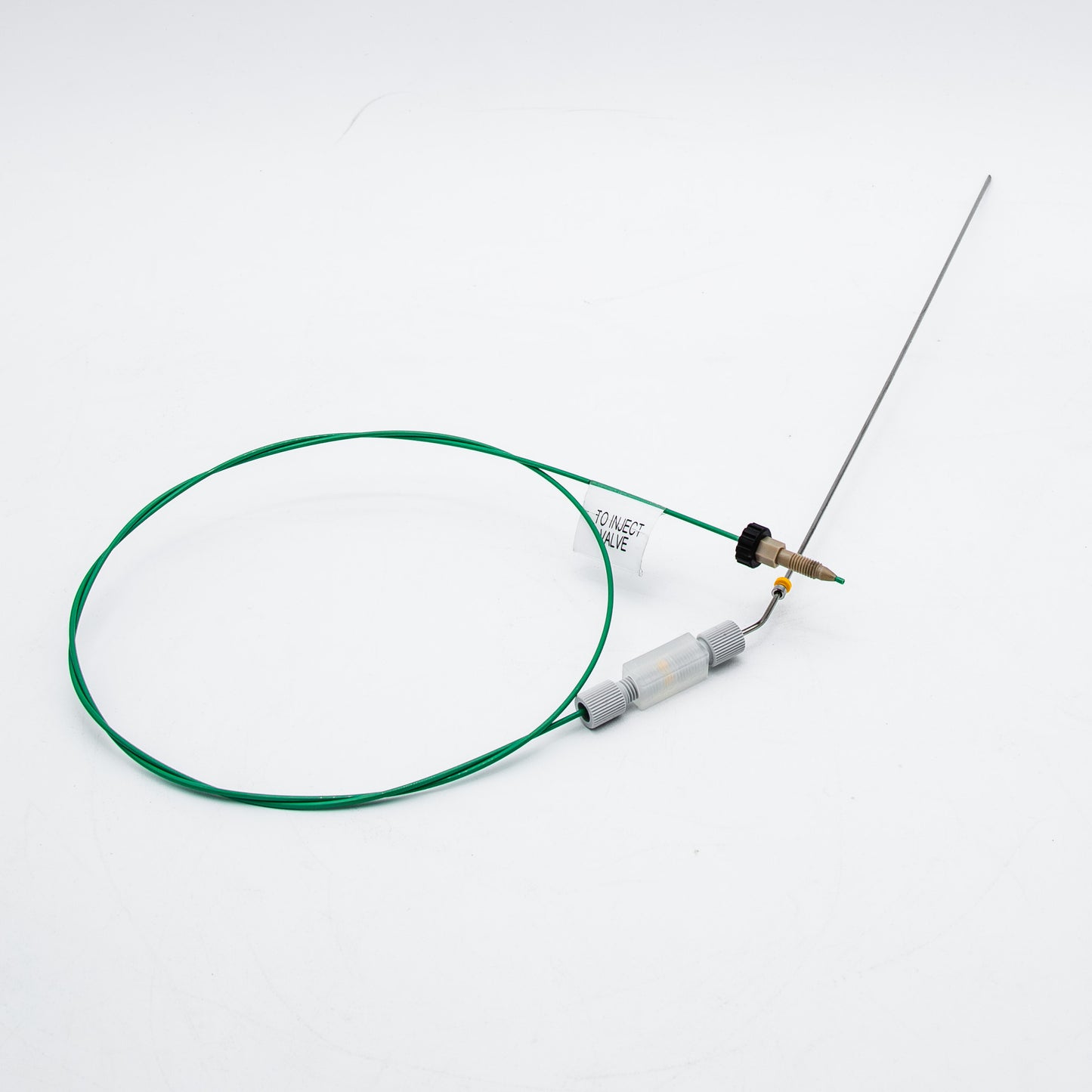 Device with green cable and needle on a white background