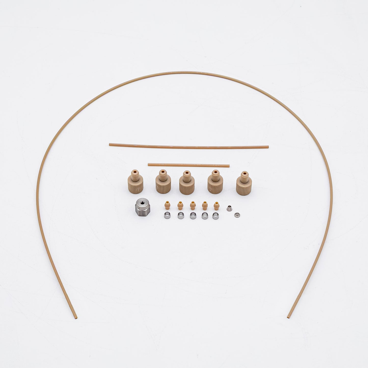 A set of tan-colored nuts and matching metal fittings arranged on a plain white background, with three varied sizes of tubing.