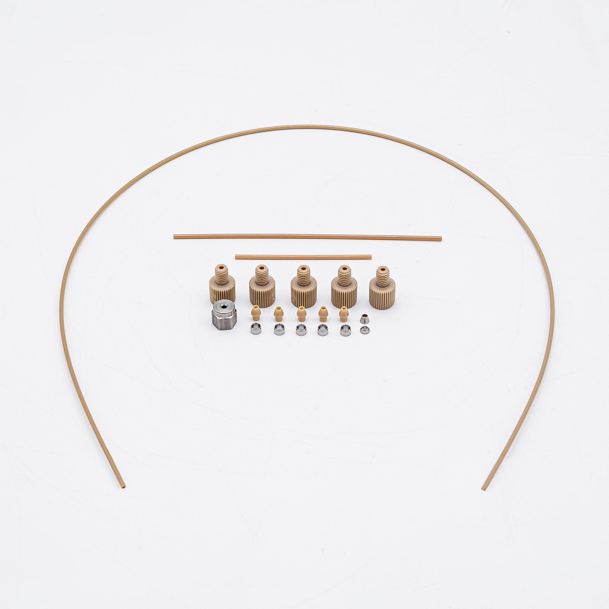 A set of tan-colored nuts and matching metal fittings arranged on a plain white background, with three varied sizes of tubing.