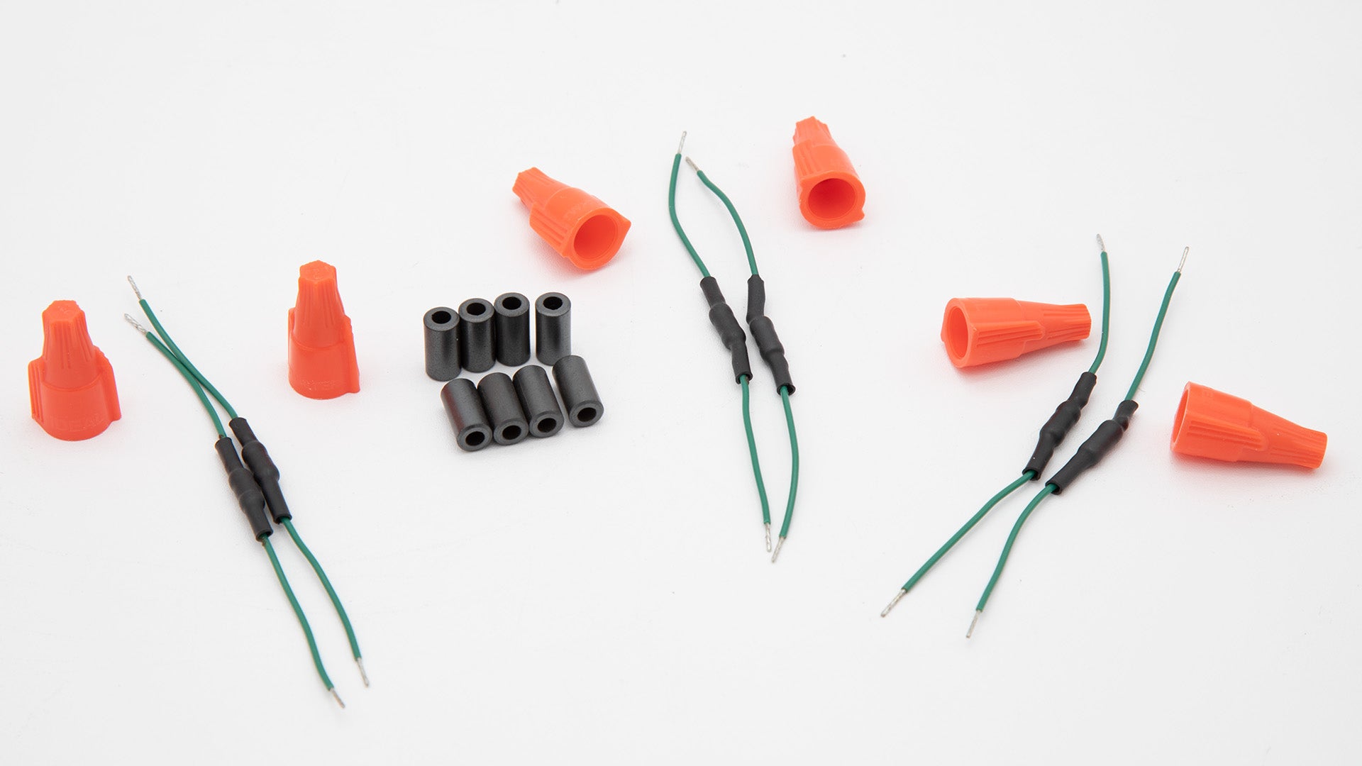 An assortment of orange and black electrical connectors, emphasizing their contrasting colors and functional design.