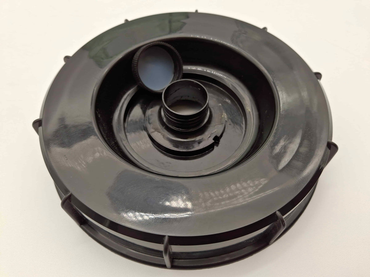 A black plastic circular component with a threaded center opening and a small detached cap, photographed on a plain white background.