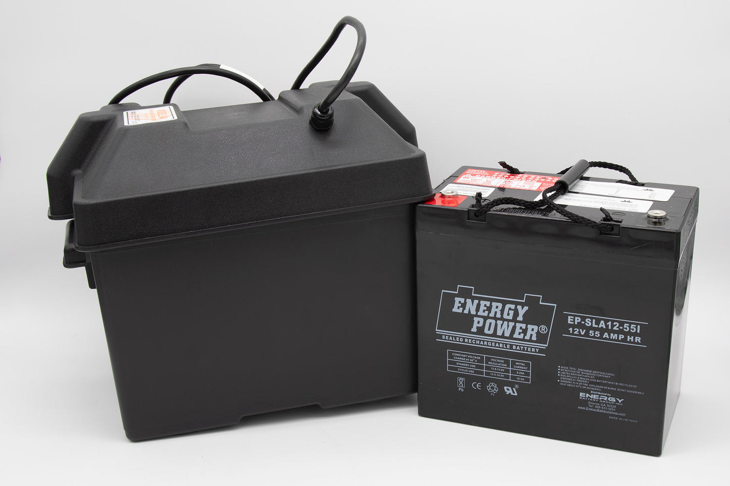 A black battery box alongside a black battery, both positioned on a neutral background, showcasing their sleek design.