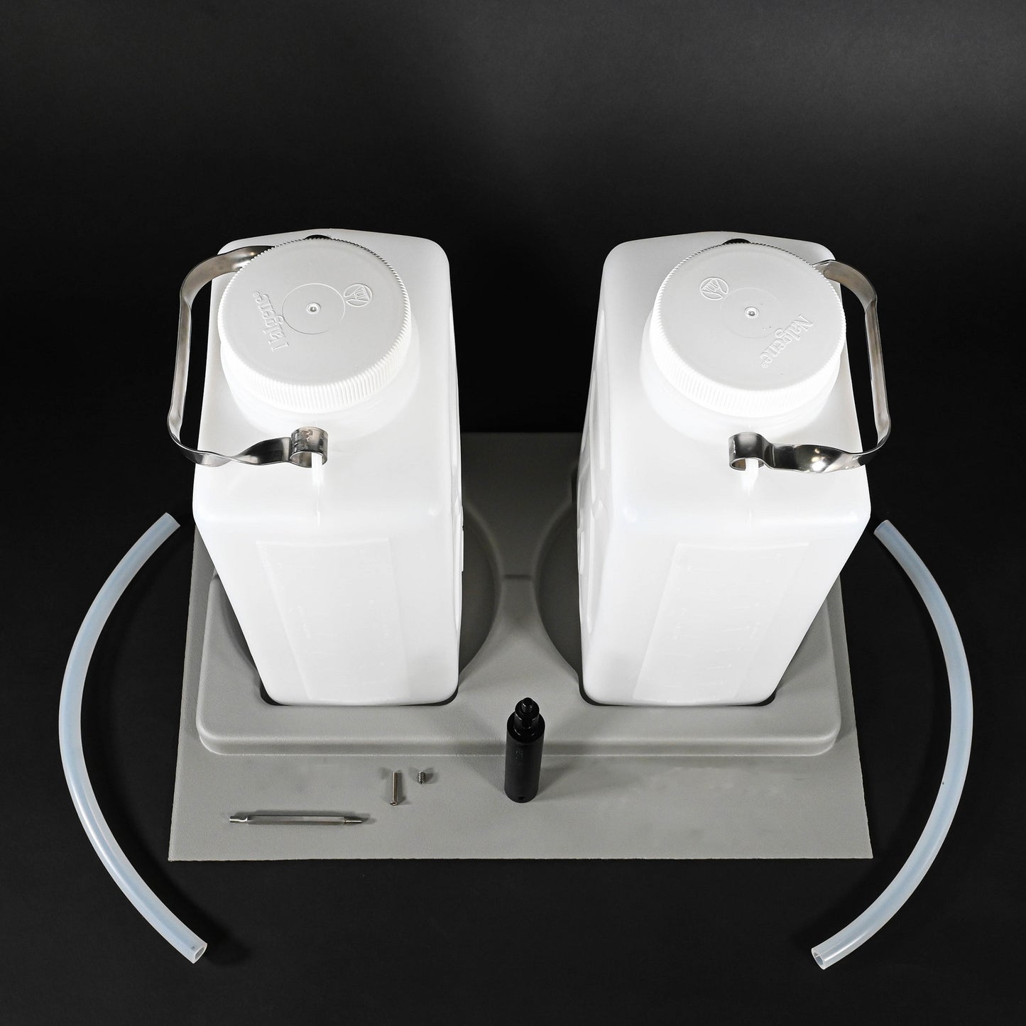 Two white water jugs placed in a grey holder, emphasizing their elegant and functional appearance.