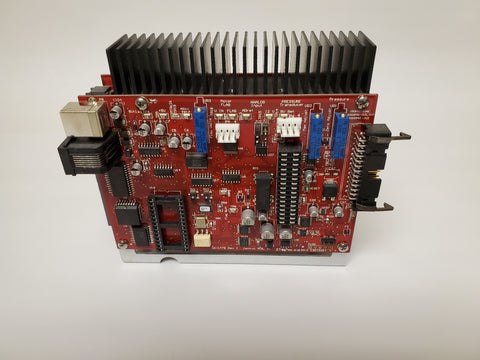 A red circuit board with black metal inserts