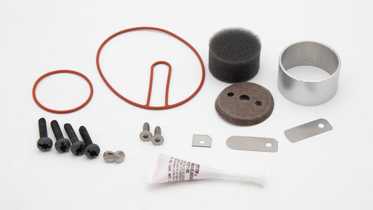 Various components of a vacuum pump, including fittings and seals, presented in an organized manner for easy identification.