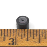 Cylindrical capsule with pass-through hole with measurement.