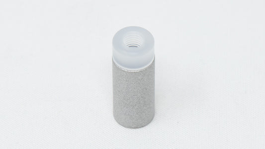 A cylindrical gray object with a clean white cap, representing a contemporary and functional design.