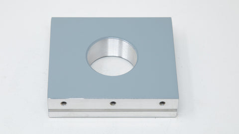 Square mounting plate with threaded ports.