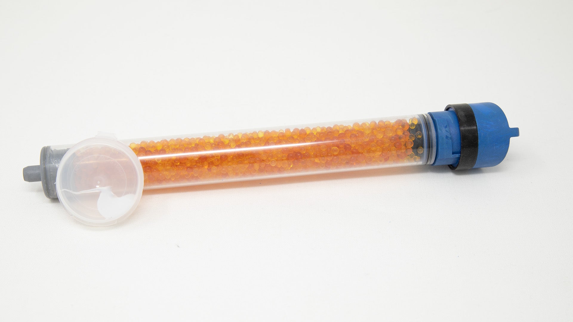 Clear plastic tube with desiccant and caps.