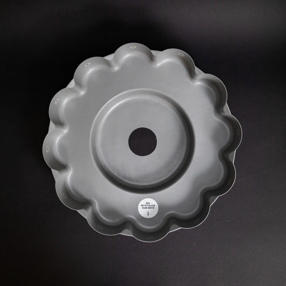 Round plastic tray with grooves for bottle placement
