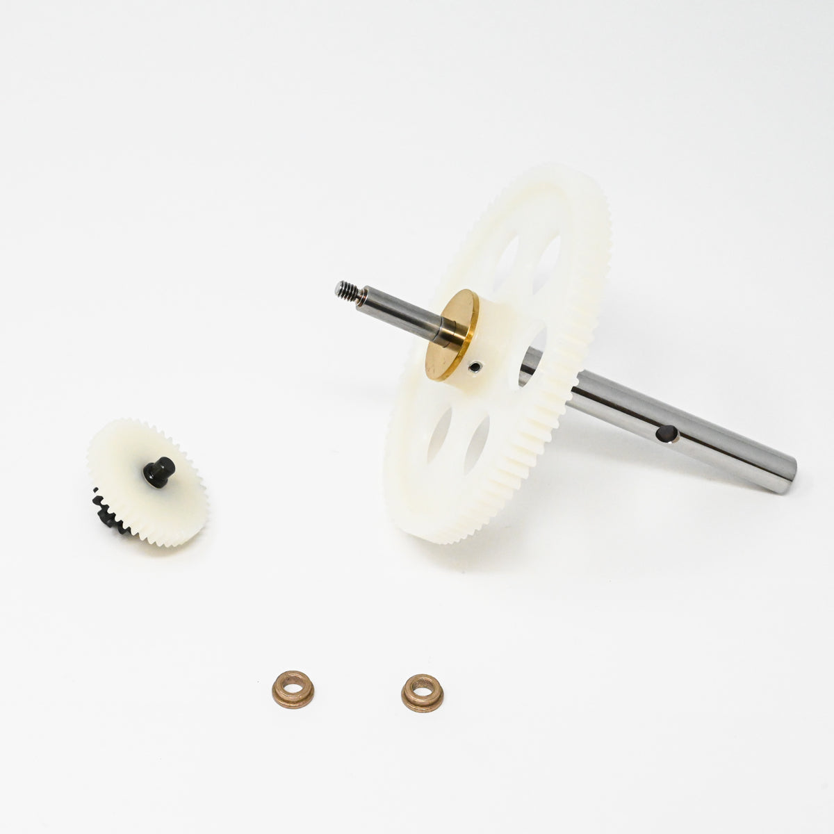 A set of gears positioned on a clean white surface, showcasing their mechanical design and functionality.