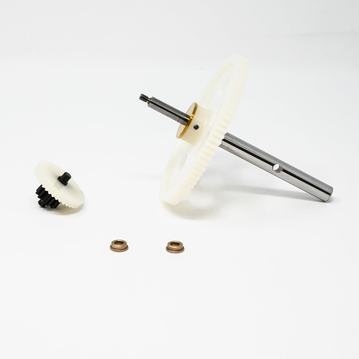 A set of gears positioned on a clean white surface, showcasing their mechanical design and functionality.