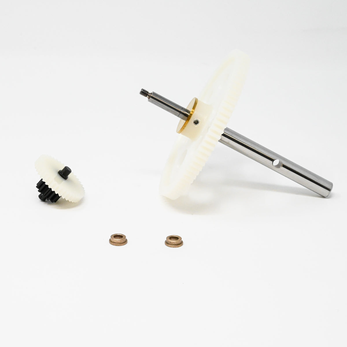 A set of gears positioned on a clean white surface, showcasing their mechanical design and functionality.