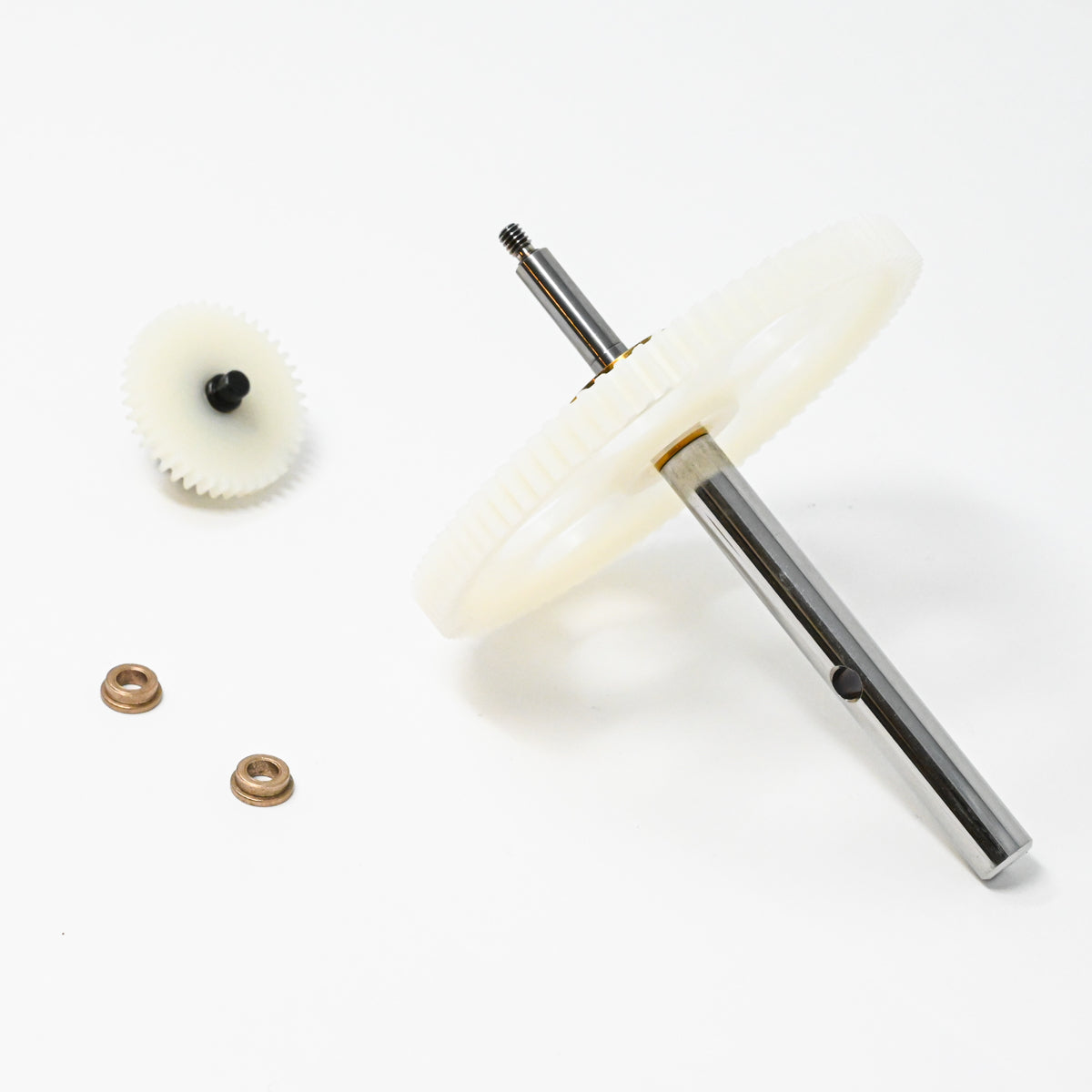 A set of gears positioned on a clean white surface, showcasing their mechanical design and functionality.