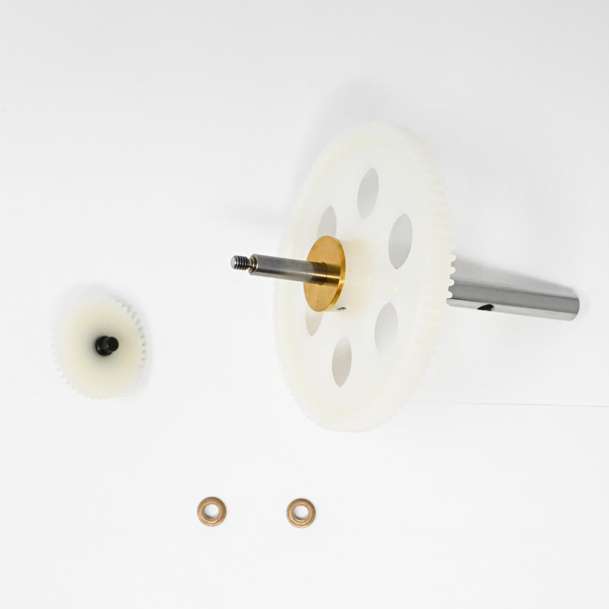 A set of gears positioned on a clean white surface, showcasing their mechanical design and functionality.