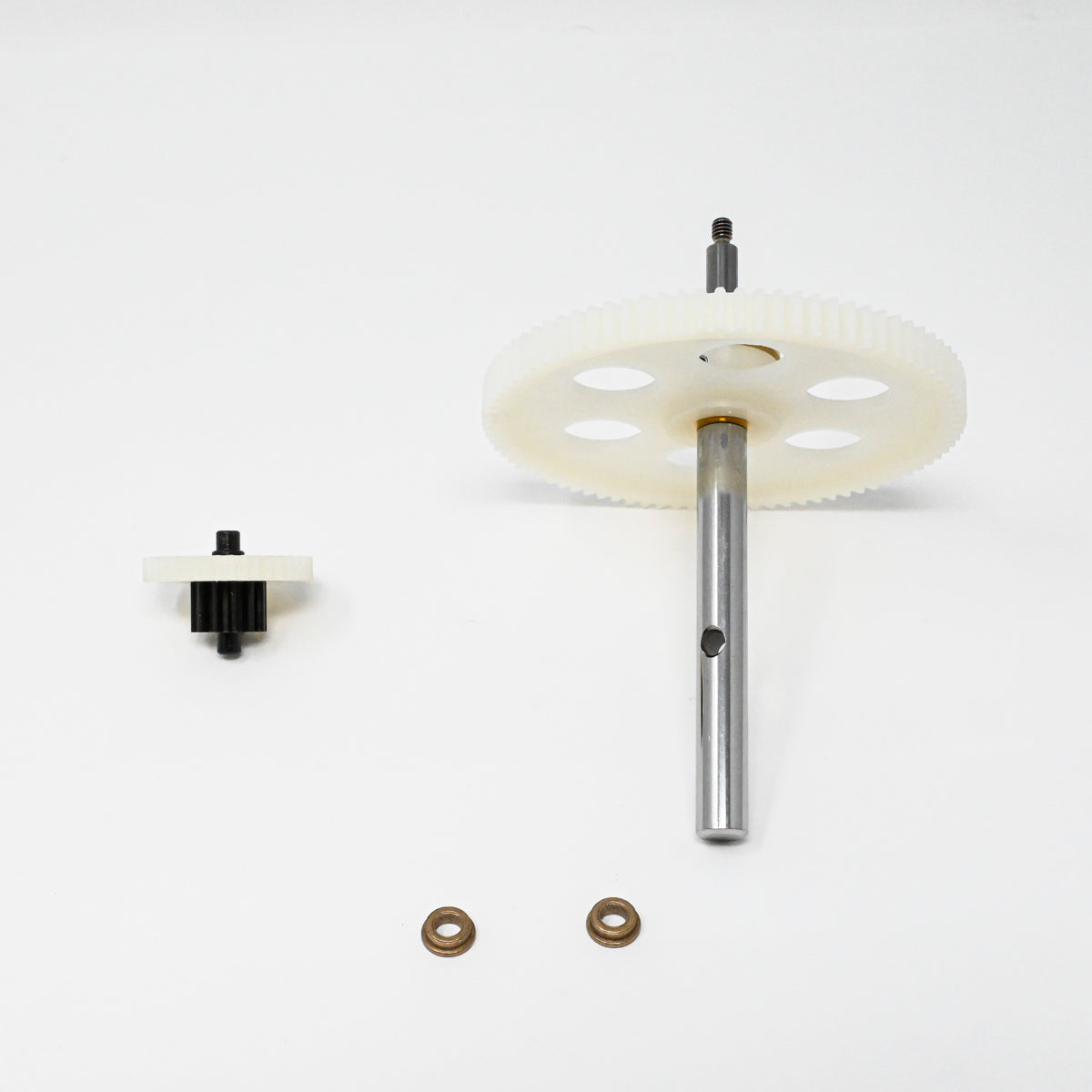 A set of gears positioned on a clean white surface, showcasing their mechanical design and functionality.