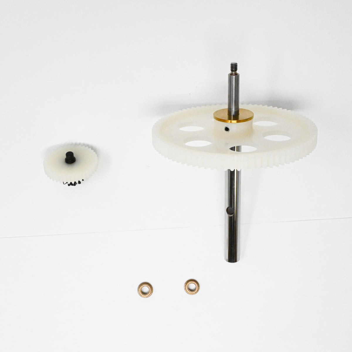 A set of gears positioned on a clean white surface, showcasing their mechanical design and functionality.