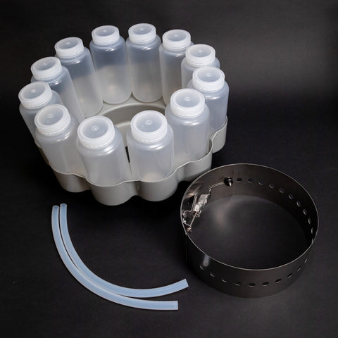 12 polypropylene round bottles with caps, base locating insert, bottle retaining ring and two discharge tubes.