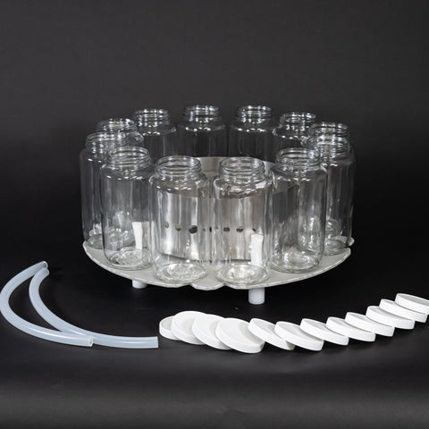 12 glass bottles with caps, base locating insert, bottle retaining ring and two discharge tubes.