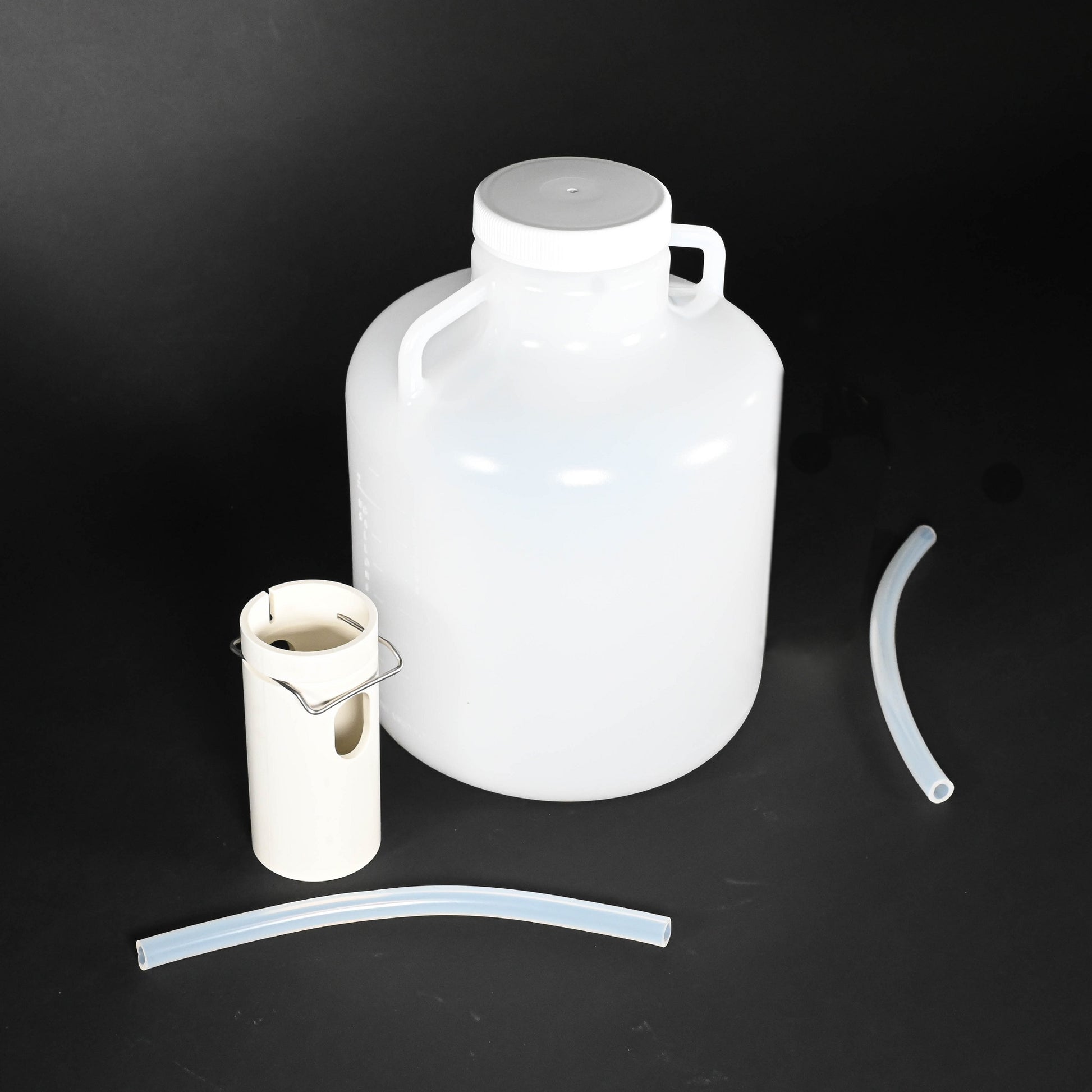 Polyethylene round bottle with cap, tube guide and two discharge tubes.  