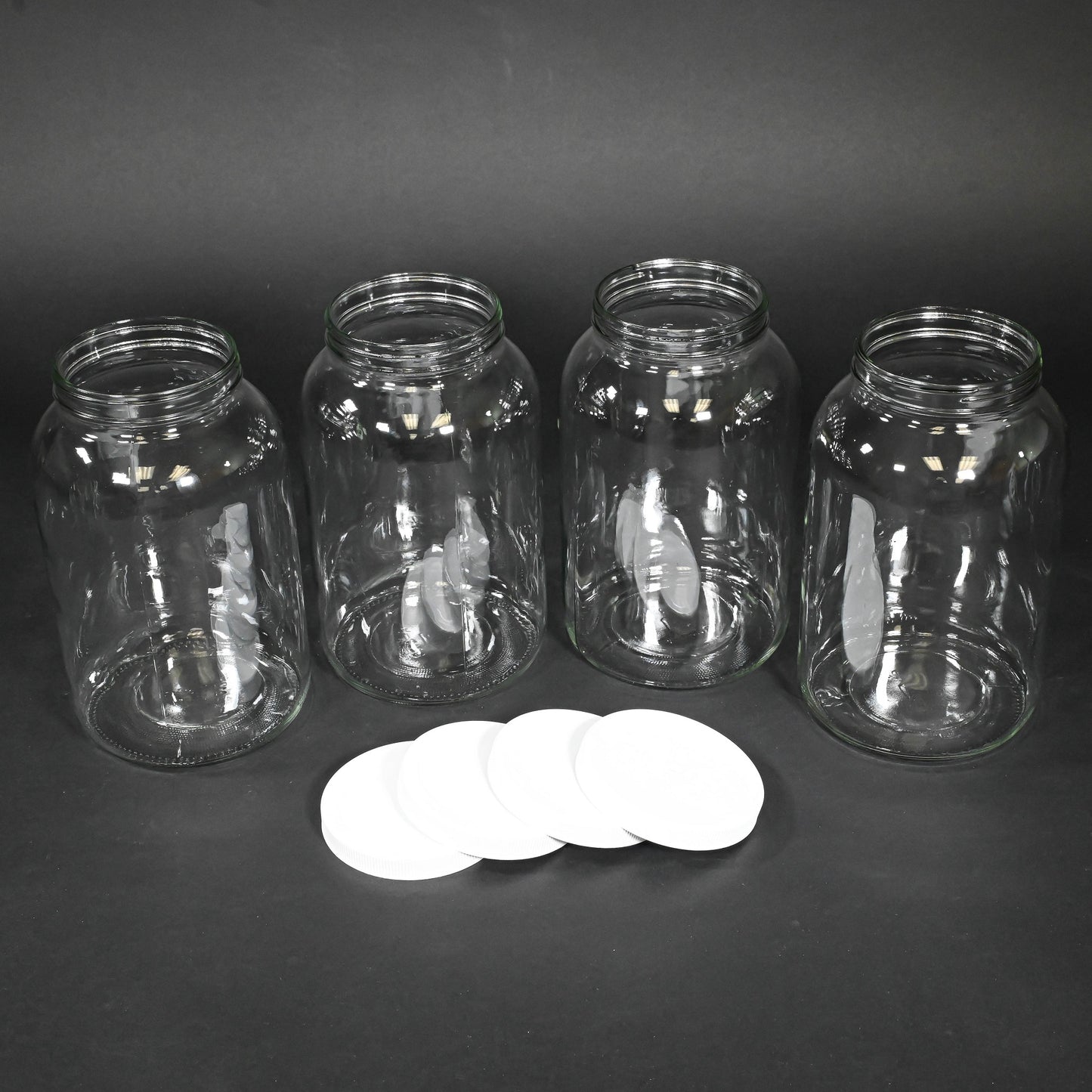 Four glass bottles with caps