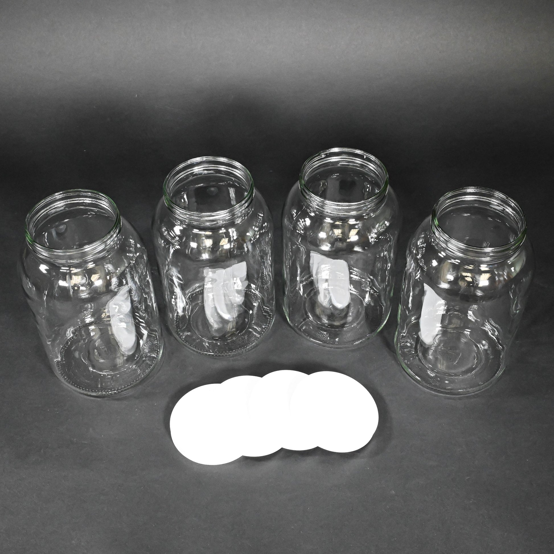 Four glass bottles with caps
