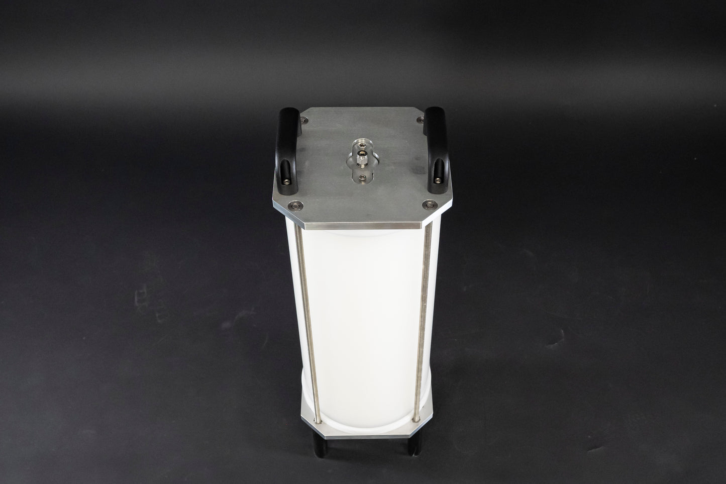 A filled white cylinder encased by stainless steel brackets and black handles, showcasing its sleek design.