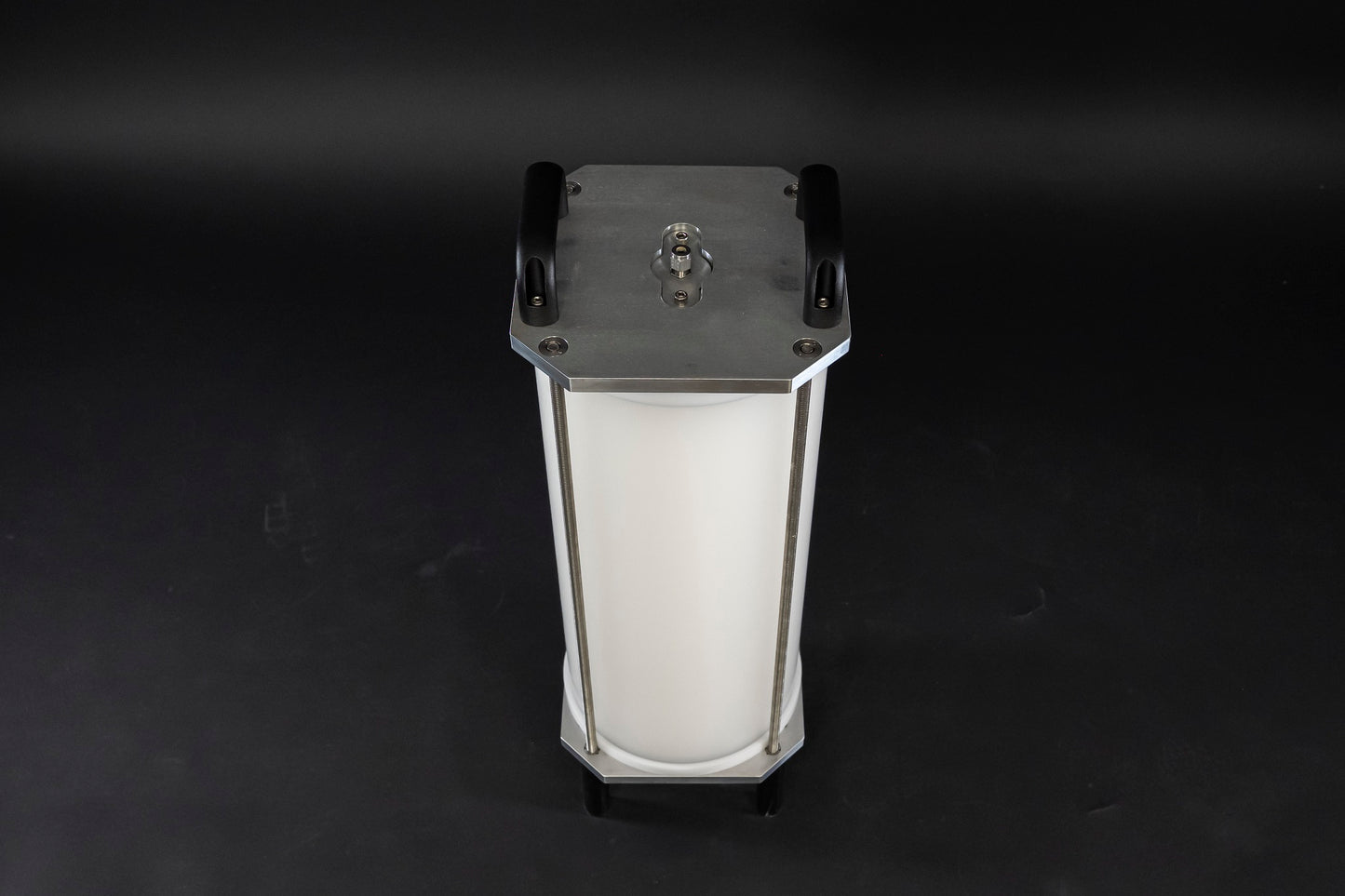 A filled white cylinder encased by stainless steel brackets and black handles, showcasing its sleek design.