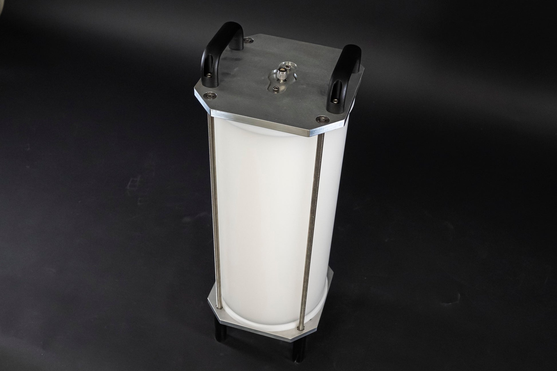 A filled white cylinder encased by stainless steel brackets and black handles, showcasing its sleek design.