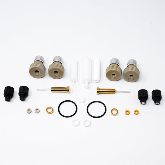 A collection of components for a pump, including various fittings and mechanical parts arranged neatly.