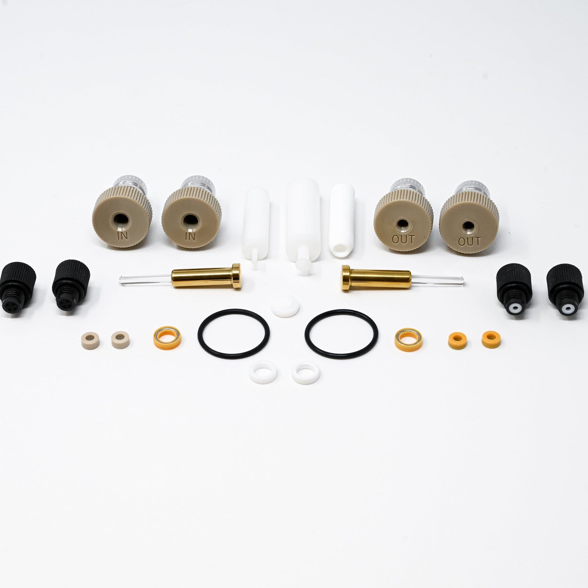 A collection of components for a pump, including various fittings and mechanical parts arranged neatly.