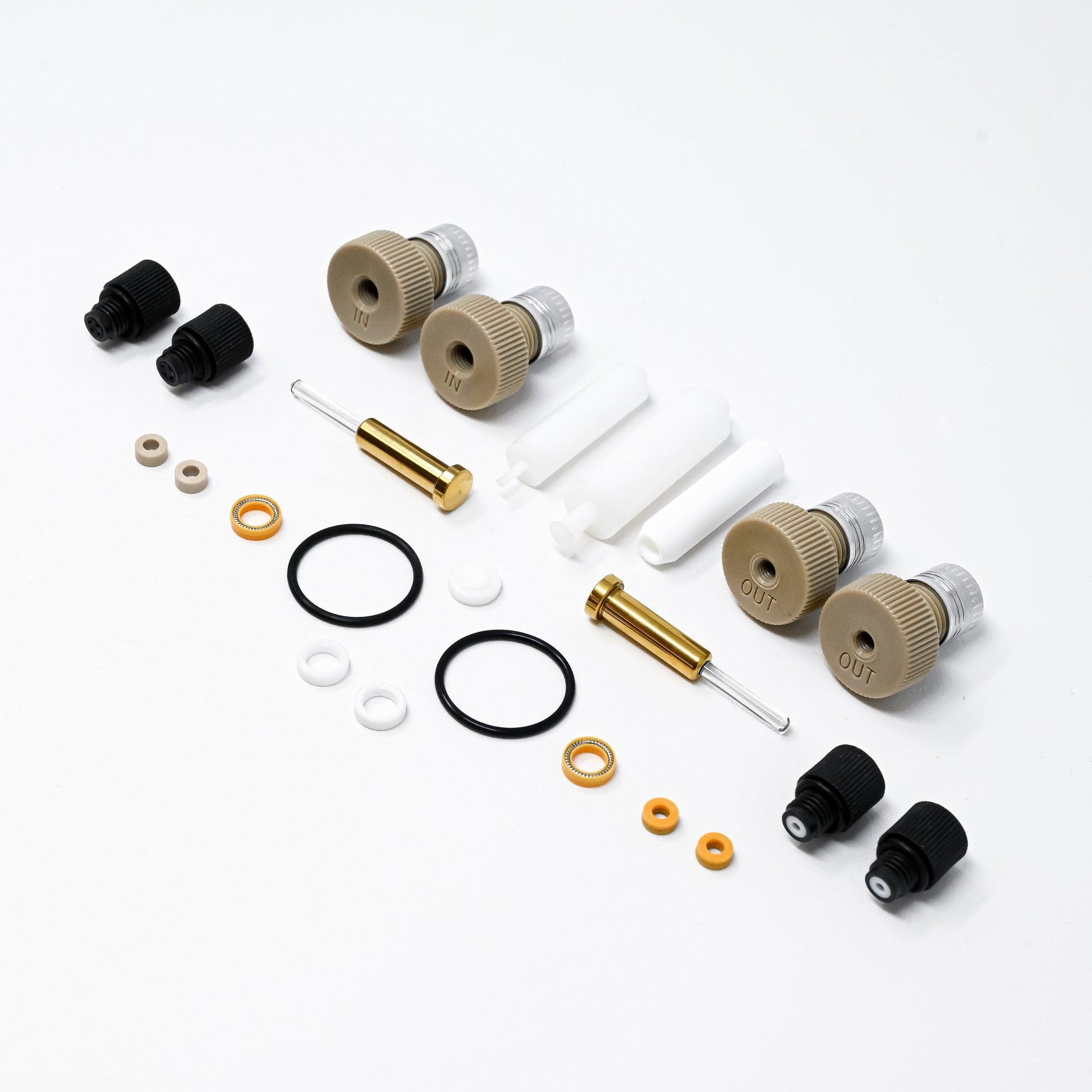 A collection of components for a pump, including various fittings and mechanical parts arranged neatly.