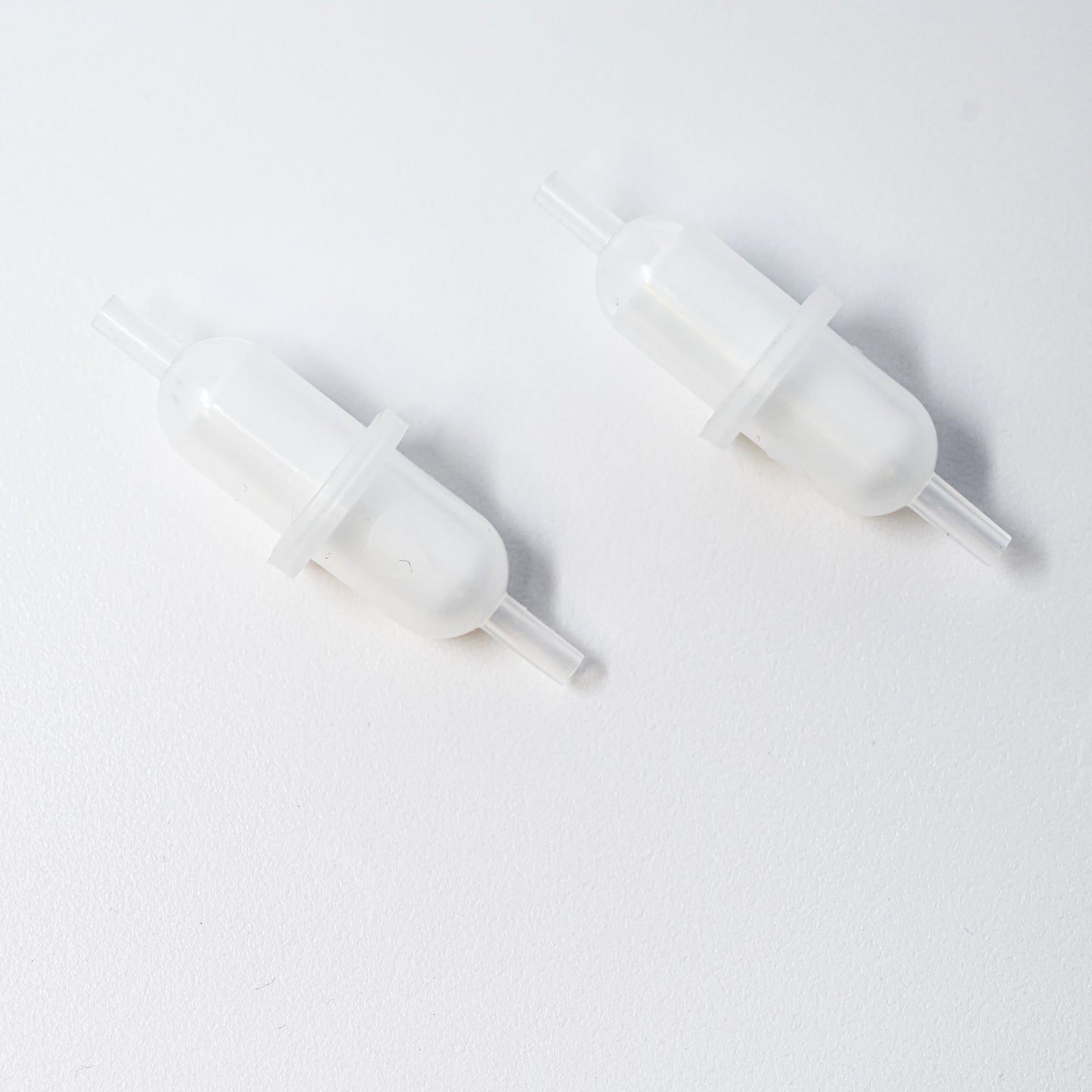 Set of plastic filters with connection points at both ends.