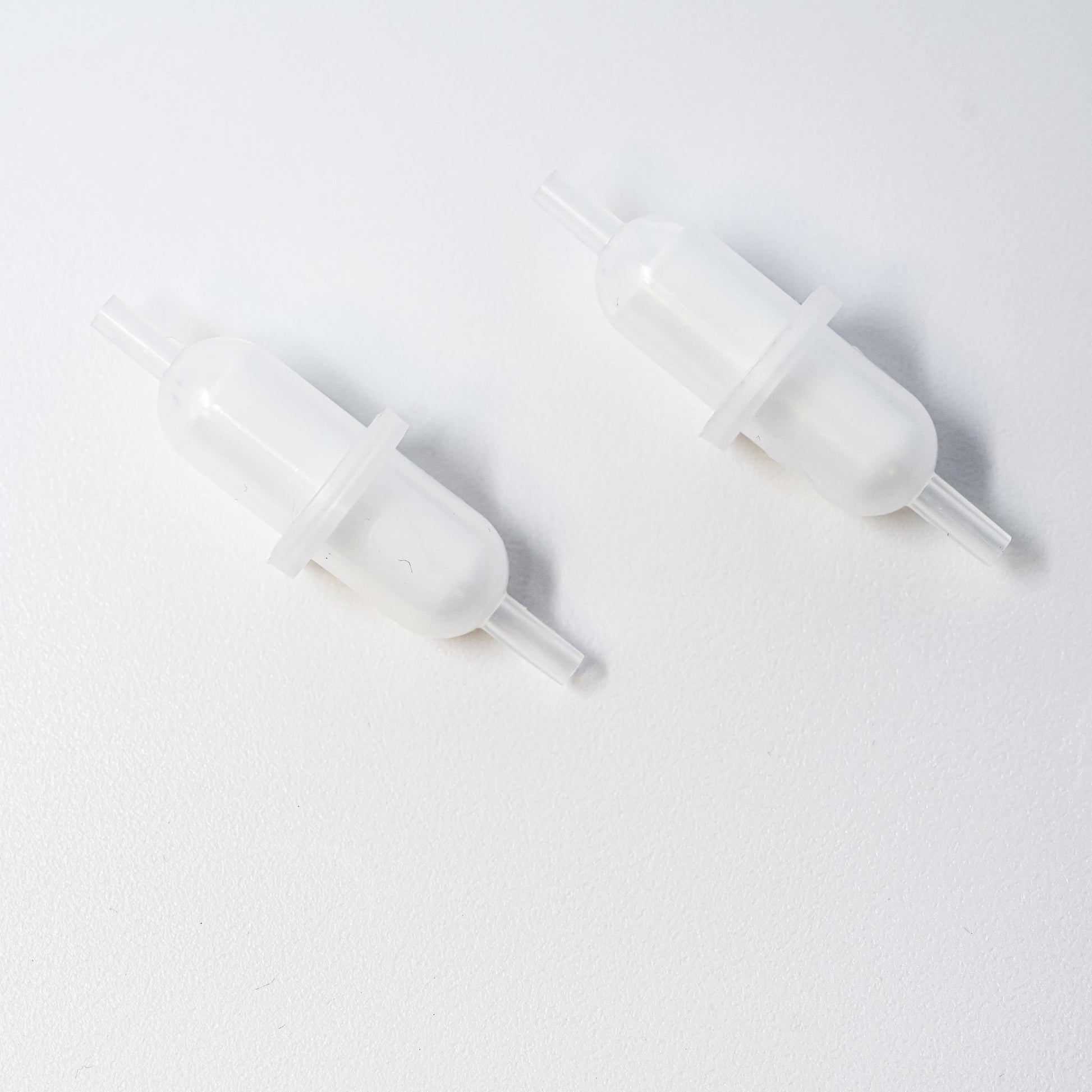 Set of plastic filters with connection points at both ends.