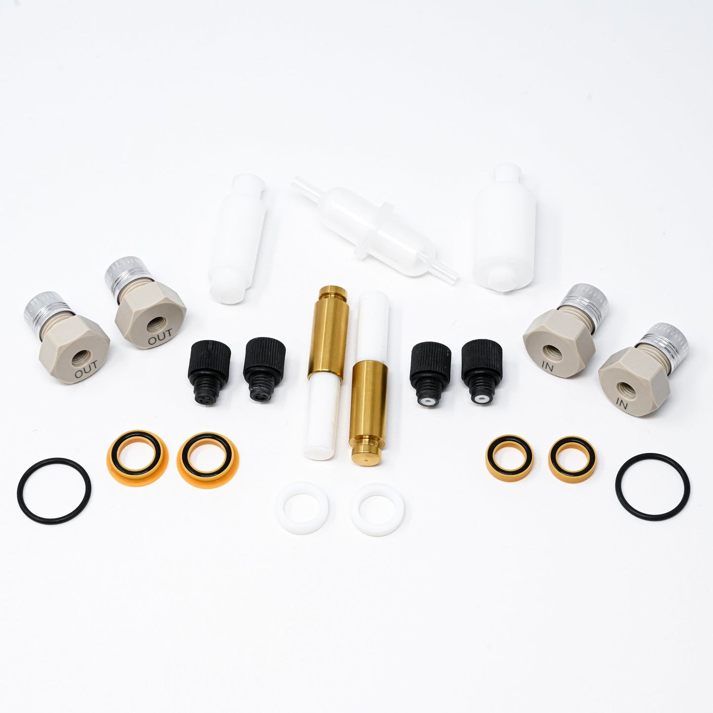 A collection of components for a pump, including various fittings and mechanical parts arranged neatly.