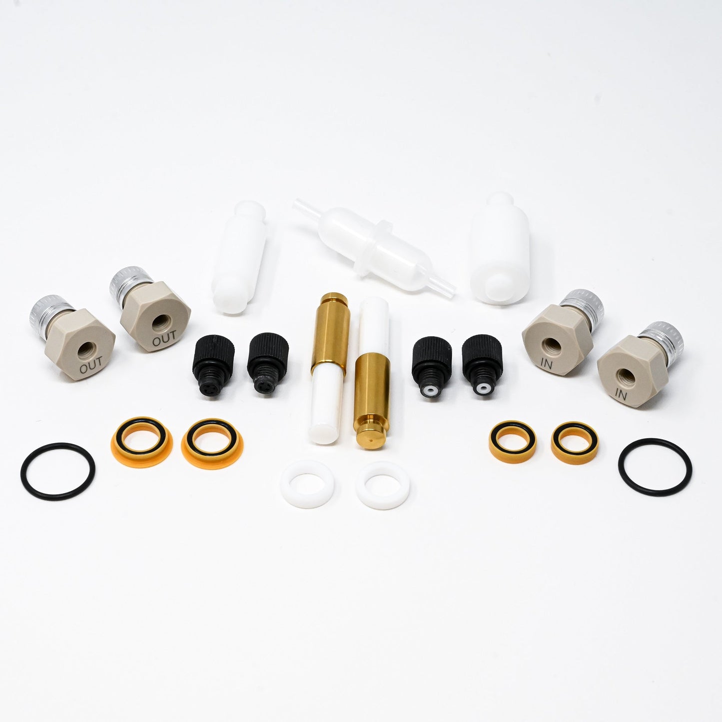 A collection of components for a pump, including various fittings and mechanical parts arranged neatly.