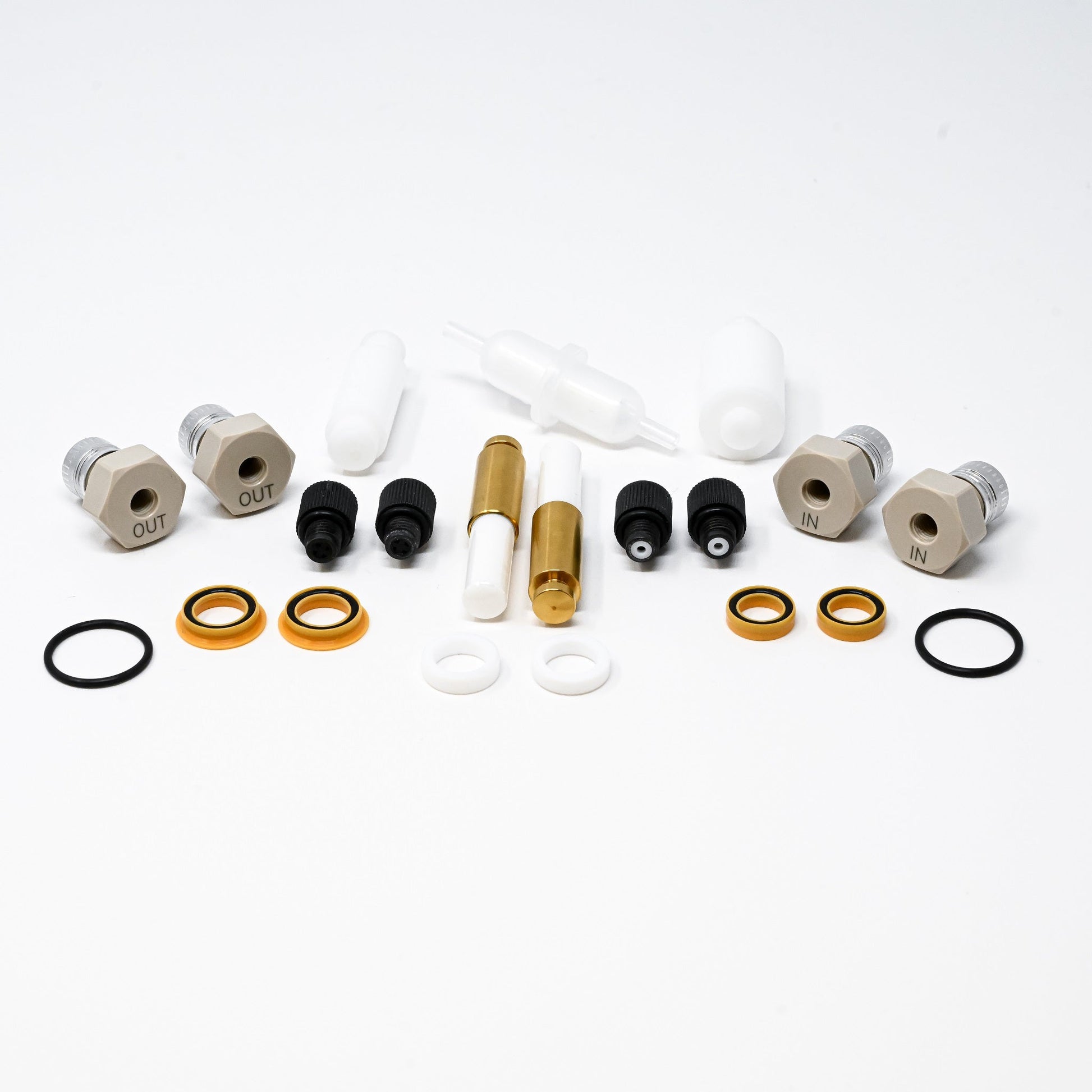 A collection of components for a pump, including various fittings and mechanical parts arranged neatly.