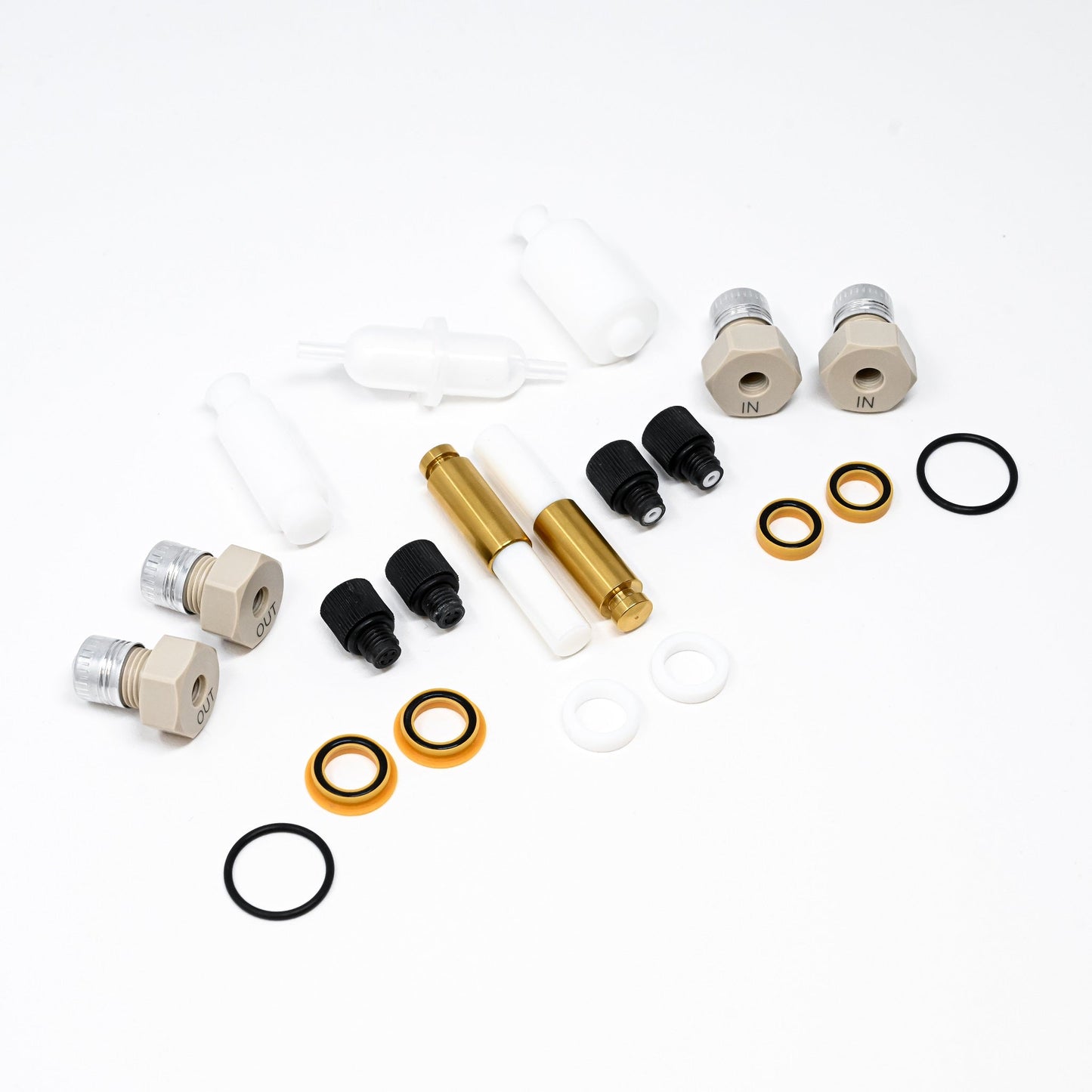 A collection of components for a pump, including various fittings and mechanical parts arranged neatly.