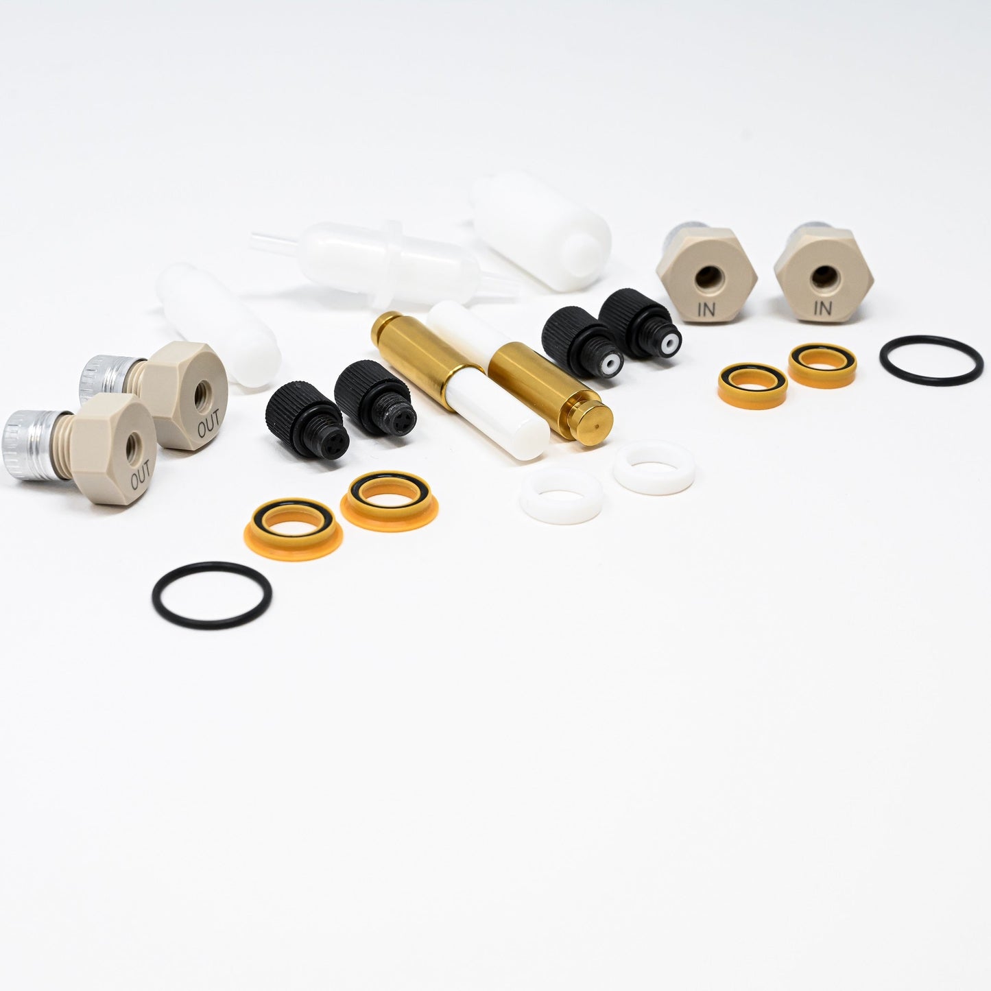 A collection of components for a pump, including various fittings and mechanical parts arranged neatly.