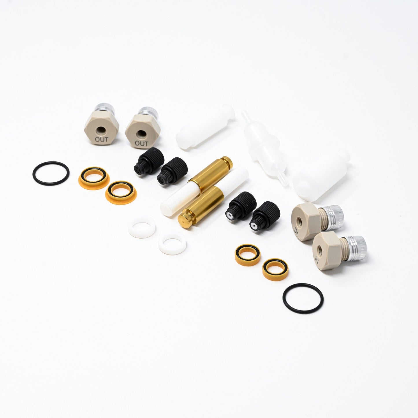 A collection of components for a pump, including various fittings and mechanical parts arranged neatly.