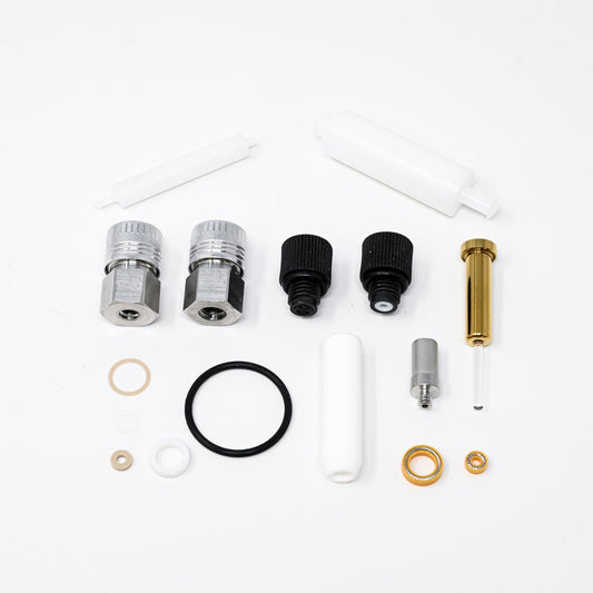 A collection of components for a pump, including various fittings and mechanical parts arranged neatly.