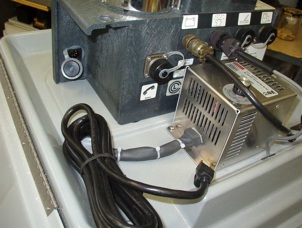 A power cord connected to a small mounted heater, indicating a setup for electrical connectivity.